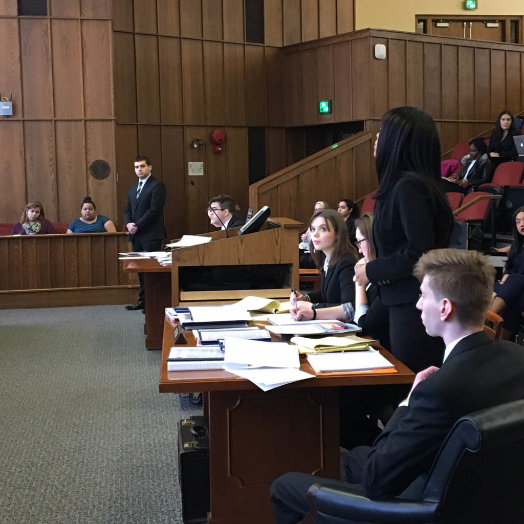 Student on the Mock Trial Team shown competing in a court room setting.