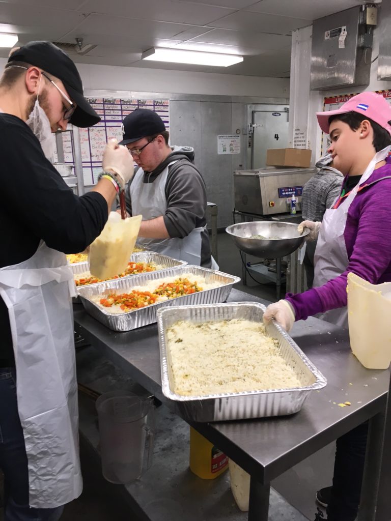 Saint Rose students preparing food at D.C. Central Kitchen, which serves those living in poverty.