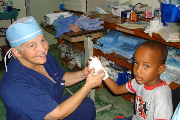 Dr. Patricia Fox helping a child in a medical clinic