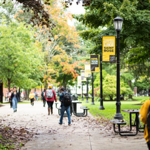 Students walking around on campus on an overcast afternoon