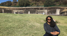 Guadalupe Chavez sitting on the grass visiting the Great Pyramids of Cholula, a small Pueblo magico outside of the state of Puebla 
