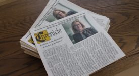 Copies of the Saint Rose Chronicle student newspaper with an article written by President Carolyn J. Stefanco at the top of the paper.
