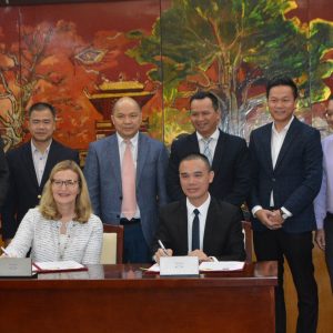 Saint Rose President Carolyn J. Stefanco signing an agreement with officials from Hanoi University in Vietnam