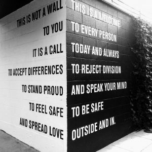 wall with a message to stay safe and spread love