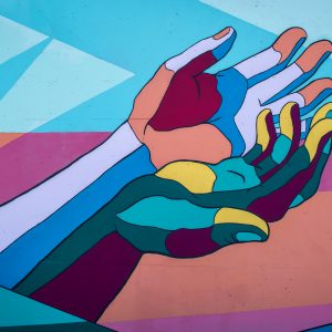 two colorful hands intertwined