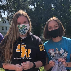 students on green with masks