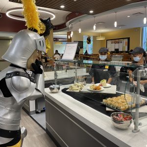 Fear, the Saint Rose mascot, getting food in the dining hall