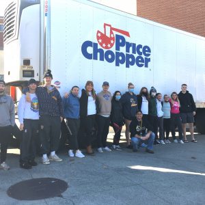 Saint Rose students and professor Mark Michalisin in front of a Price Chopper truck