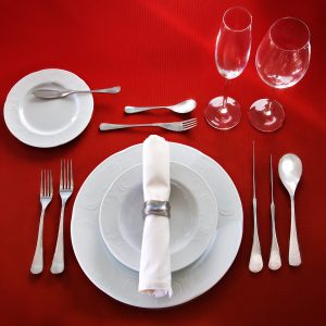 Perfect table setting on red cloth background